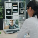 Healthcare provider reviewing patient symptoms during a telehealth consultation for a medical certificate